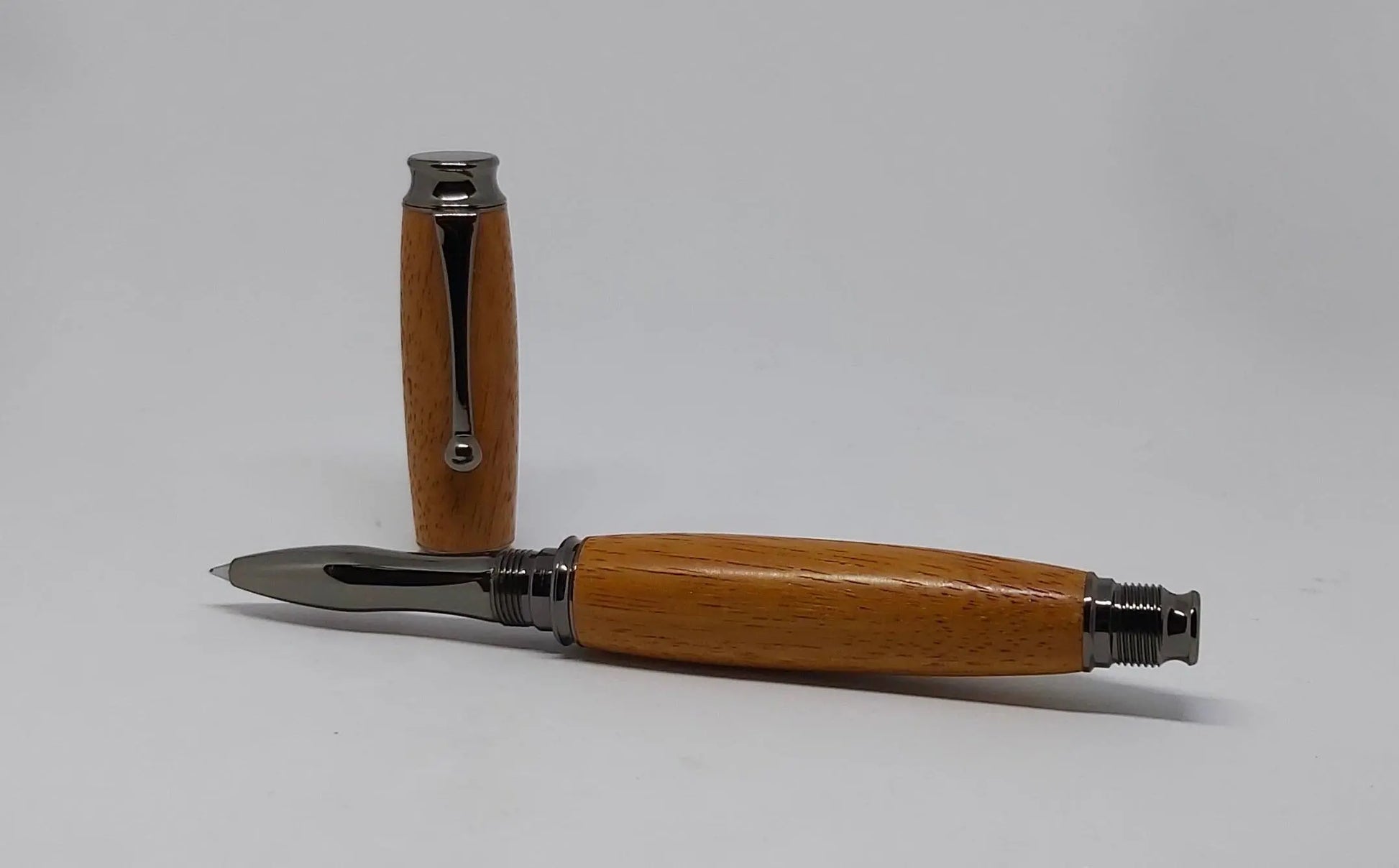 Rollerball pen handmade in Iroko wood from Phoenix Wharf, Plymouth. DevonPens